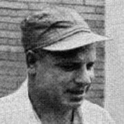 Old photo of a smiling man in a baseball cap